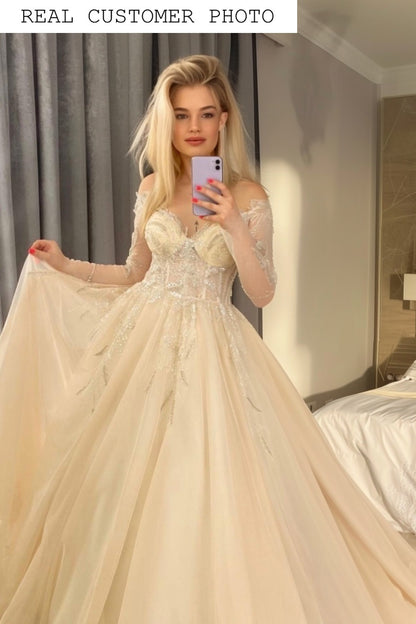 Off the shoulder long sleeve blush wedding dress