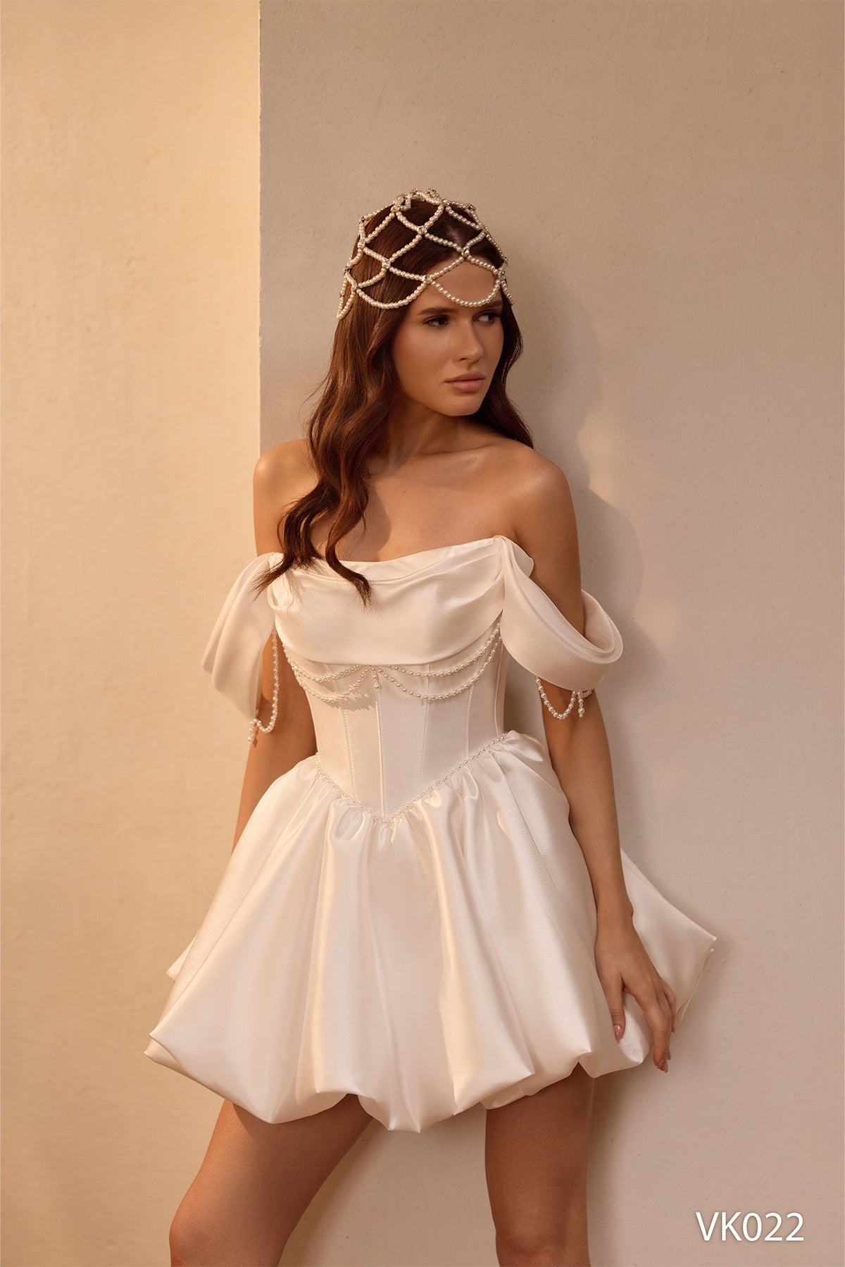 Pearl Bridal Mini Dress in ivory satin with off-shoulder draped sleeves, corset bodice, pearl chain embellishments, and bubble skirt